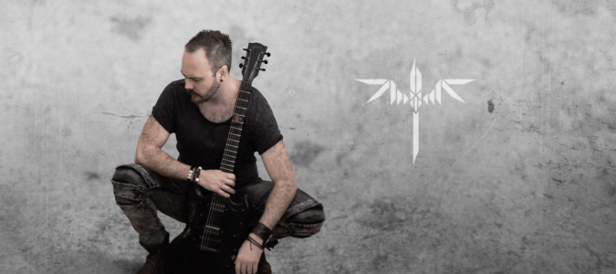 Sundergeist member promo photo Ric crouching with guitar