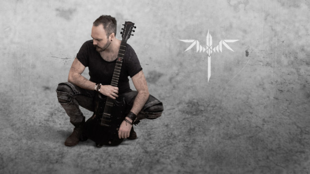 Sundergeist member promo photo Ric crouching with guitar