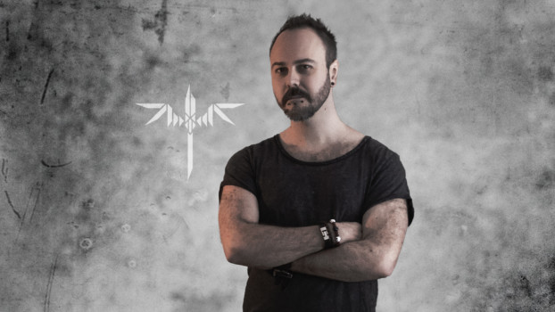 Sundergeist member promo photo Ric arms crossed with logo