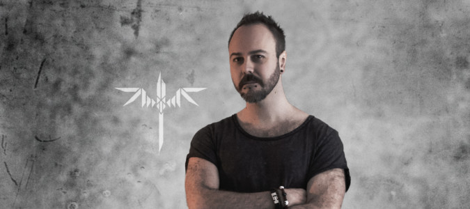 Sundergeist member promo photo Ric arms crossed with logo