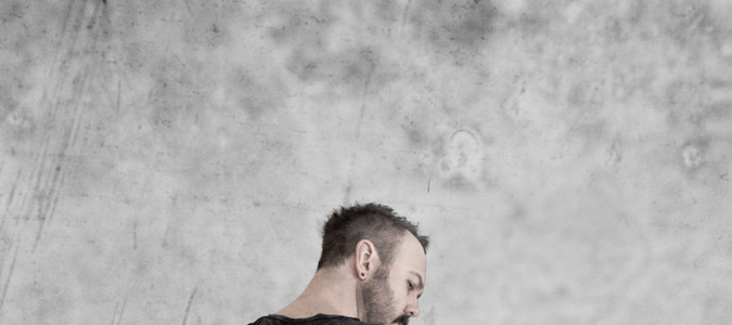 Sundergeist member promo photo Ric back turned with guitar